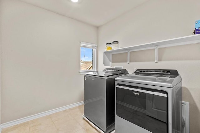 488 Pepperbark Loop, Buda, TX 78610 - laundry area with independent washer and dryer, baseboards, and light tile patterned flooring