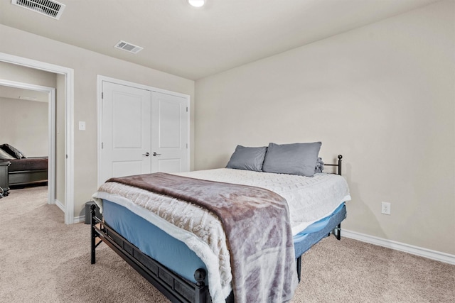 bedroom with light colored carpet and a closet