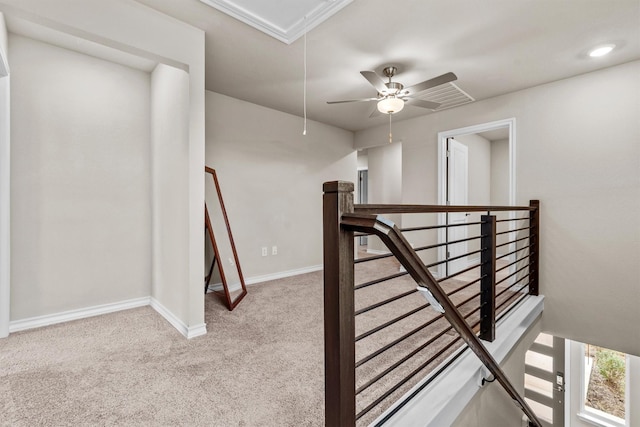 hallway featuring light colored carpet and ornamental molding