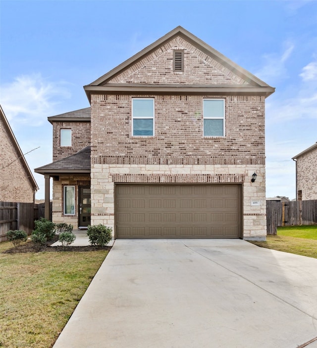 view of property featuring a garage and a front lawn