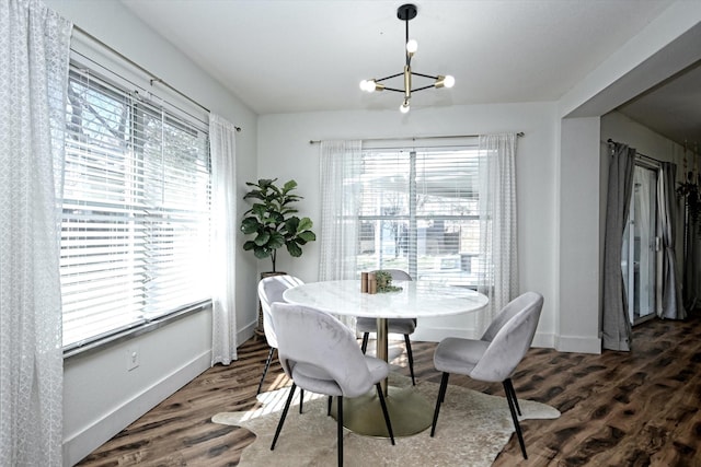 dining area featuring dark hardwood / wood-style floors and a chandelier