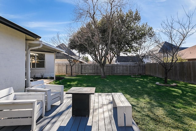 wooden terrace featuring a lawn and an outdoor living space with a fire pit