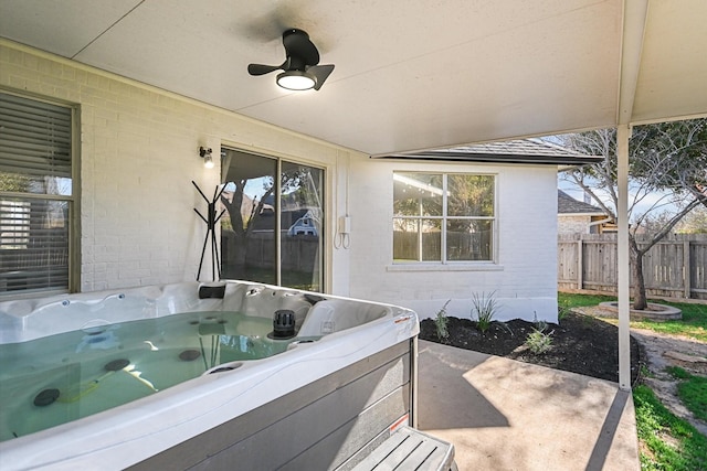 view of patio / terrace with a hot tub and ceiling fan