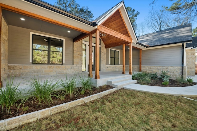 view of exterior entry with a yard