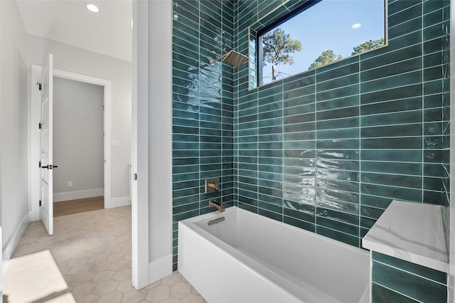 bathroom featuring tile patterned floors and tiled shower / bath combo