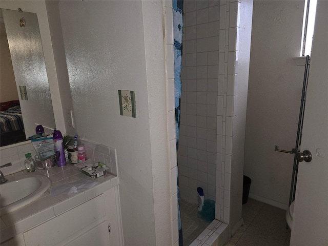 bathroom featuring curtained shower, tile patterned floors, and vanity