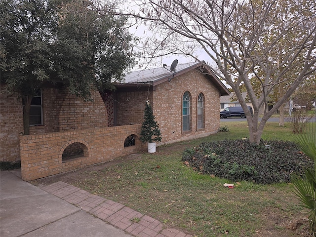 view of home's exterior with a lawn