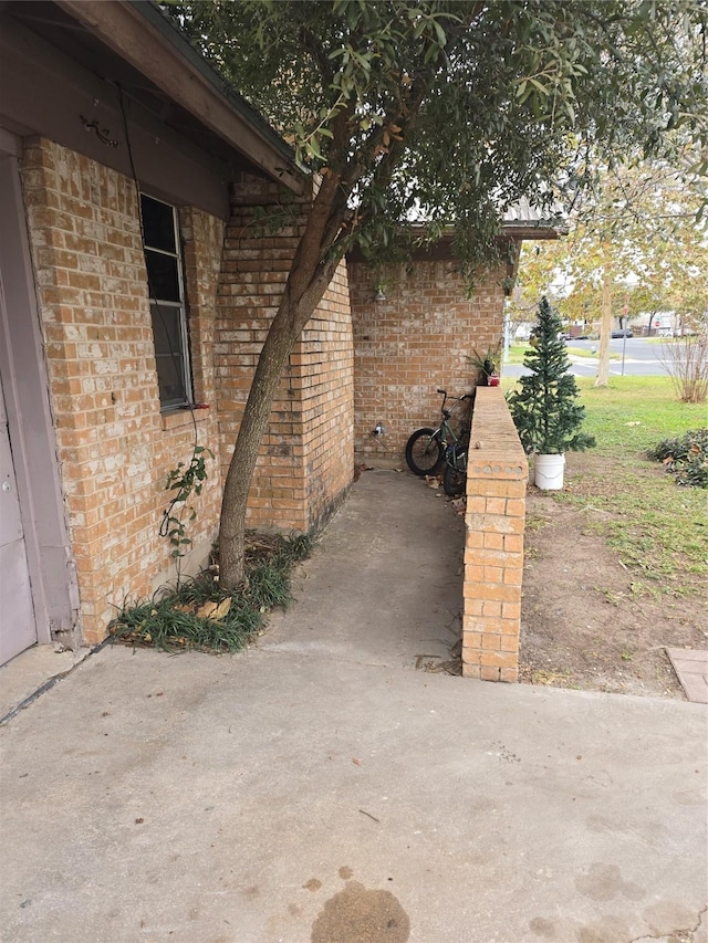 view of property exterior with a patio area