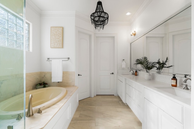 bathroom with a tub, ornamental molding, and vanity