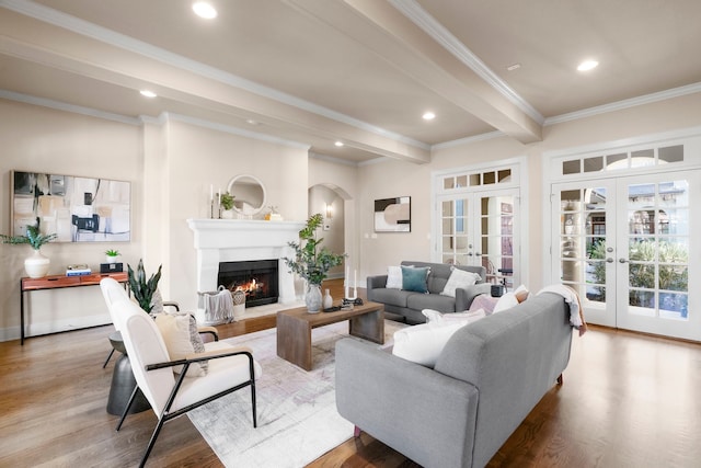 living room with crown molding, hardwood / wood-style flooring, beamed ceiling, and french doors