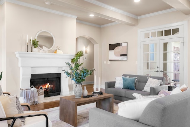 living room featuring ornamental molding, french doors, beamed ceiling, and light hardwood / wood-style flooring