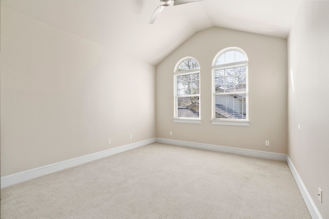 carpeted spare room featuring ceiling fan and lofted ceiling