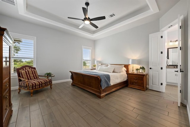 210 Miranda Way, Georgetown, TX 78633 - bedroom with a raised ceiling, light wood-style flooring, and a ceiling fan