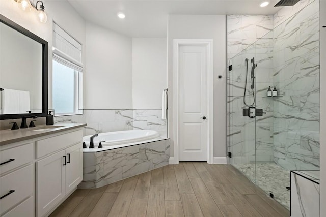 210 Miranda Way, Georgetown, TX 78633 - full bath featuring a bath, a marble finish shower, vanity, recessed lighting, and wood finished floors