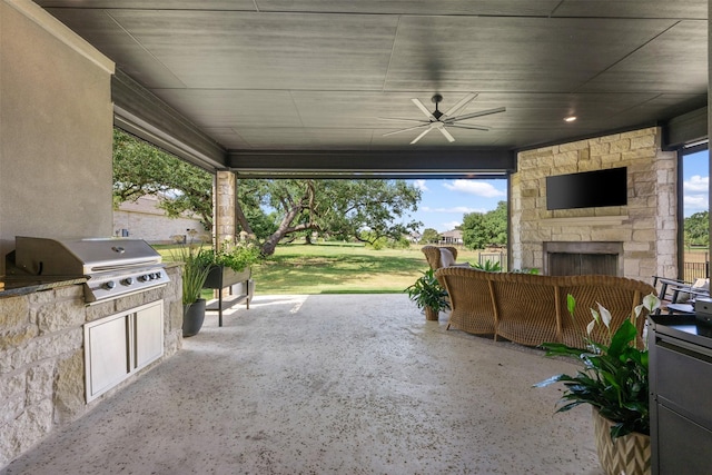 view of patio featuring ceiling fan, an outdoor kitchen, an outdoor living space with a fireplace, and a grill