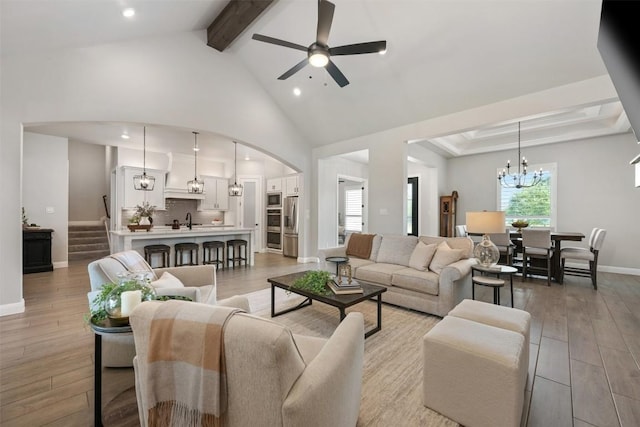 210 Miranda Way, Georgetown, TX 78633 - living room with beamed ceiling, a chandelier, light wood finished floors, ceiling fan, and high vaulted ceiling