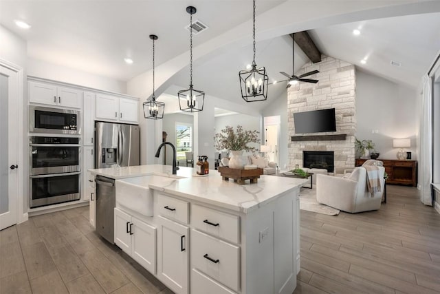 210 Miranda Way, Georgetown, TX 78633 - kitchen featuring a sink, appliances with stainless steel finishes, light wood-style flooring, a ceiling fan, and recessed lighting