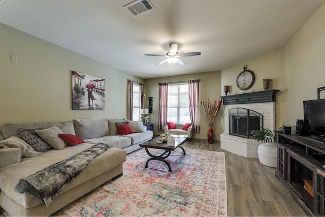 living room featuring ceiling fan and dark wood-type flooring