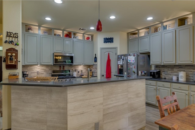 kitchen with decorative light fixtures, backsplash, gray cabinetry, and appliances with stainless steel finishes