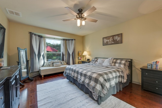 bedroom with dark hardwood / wood-style floors and ceiling fan