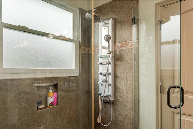 bathroom featuring a healthy amount of sunlight and an enclosed shower