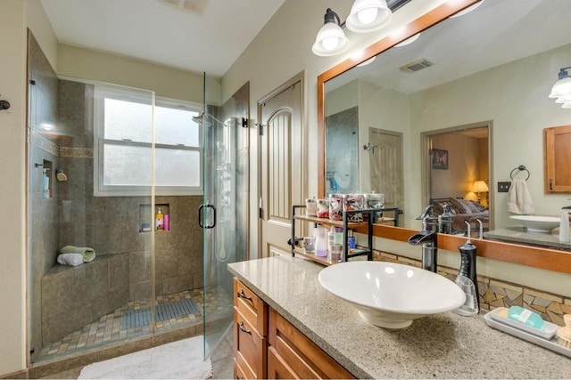 bathroom featuring a stall shower, visible vents, and vanity