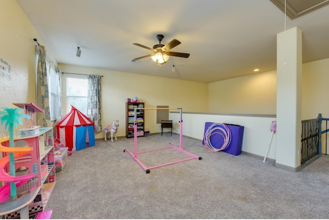 playroom with carpet, visible vents, attic access, a ceiling fan, and baseboards