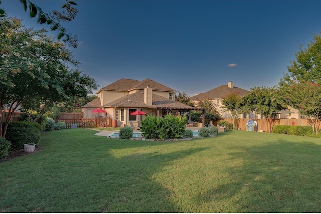 exterior space featuring a lawn, a fenced backyard, and a fenced in pool