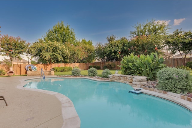 view of swimming pool featuring a fenced in pool, a patio area, and a fenced backyard