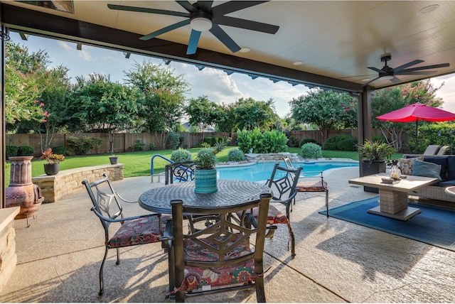 view of patio / terrace featuring a fenced in pool and ceiling fan