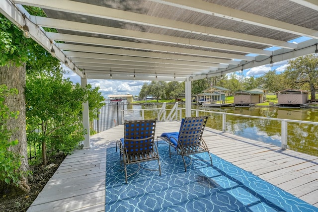 view of dock with a water view and a pergola