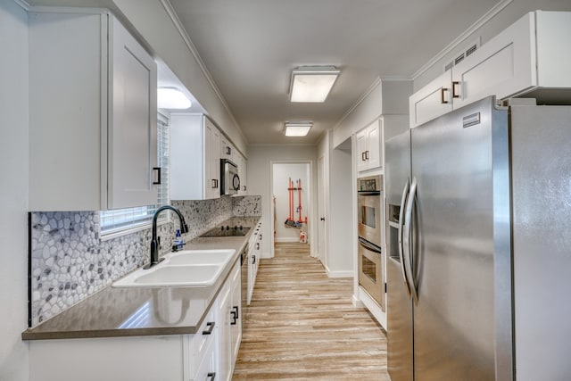 kitchen featuring sink, white cabinetry, and appliances with stainless steel finishes