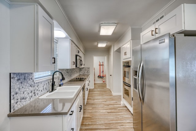 614 E Briarway Dr, Granite Shoals, TX 78654 - kitchen with stainless steel appliances, a sink, light wood finished floors, tasteful backsplash, and white cabinets