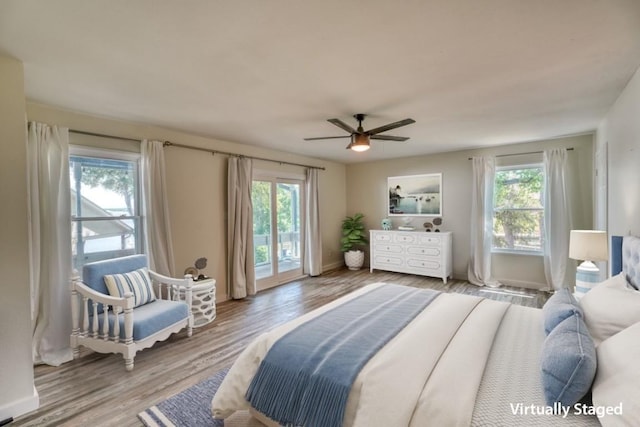 614 E Briarway Dr, Granite Shoals, TX 78654 - bedroom featuring multiple windows, access to exterior, wood finished floors, and ceiling fan