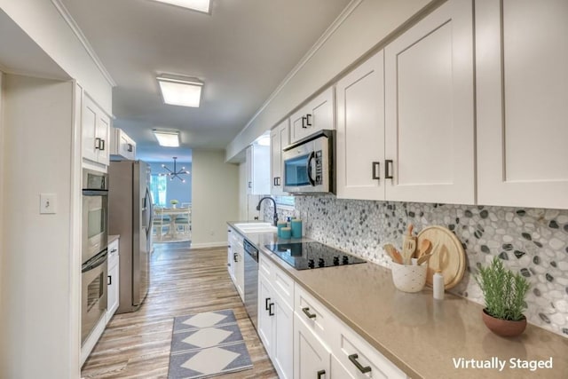 614 E Briarway Dr, Granite Shoals, TX 78654 - kitchen featuring stainless steel appliances, backsplash, light wood finished floors, white cabinetry, and light countertops