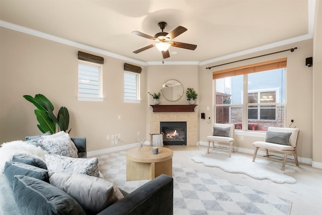 carpeted living room with a fireplace, ornamental molding, and ceiling fan