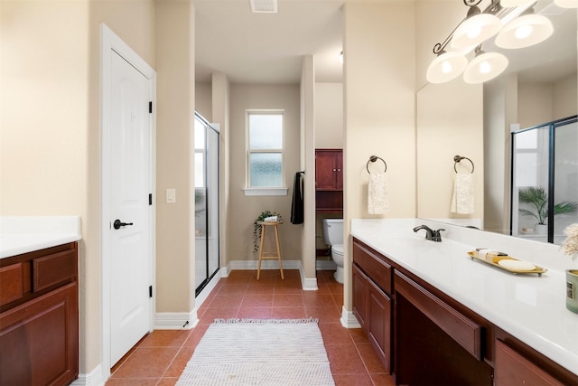 bathroom featuring an enclosed shower, vanity, tile patterned floors, and toilet