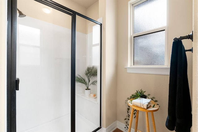 bathroom with an enclosed shower and a wealth of natural light