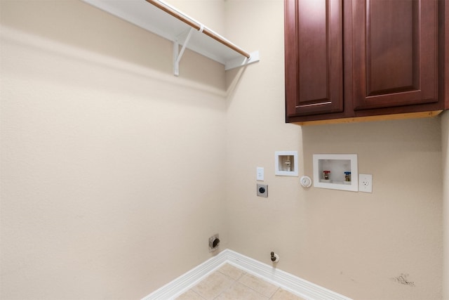 laundry room with light tile patterned flooring, hookup for a gas dryer, cabinets, hookup for a washing machine, and hookup for an electric dryer