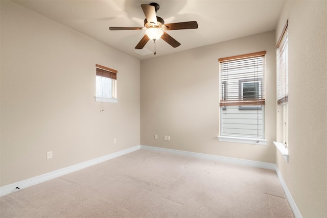 empty room featuring light colored carpet and ceiling fan