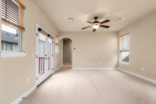 carpeted empty room featuring ceiling fan