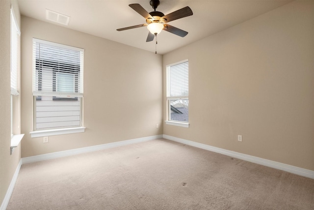 unfurnished room featuring light carpet and ceiling fan