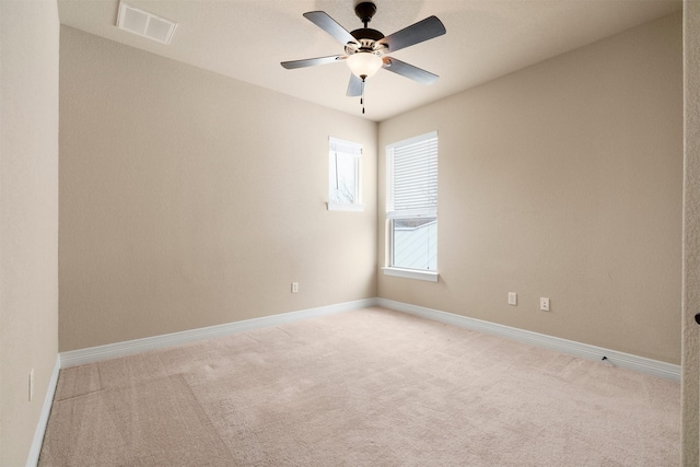 empty room with light colored carpet and ceiling fan