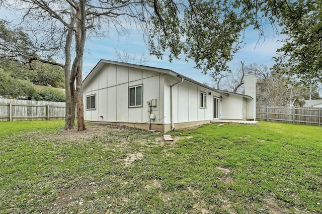 back of property featuring a yard