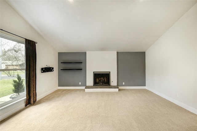 unfurnished living room with light carpet and a wealth of natural light