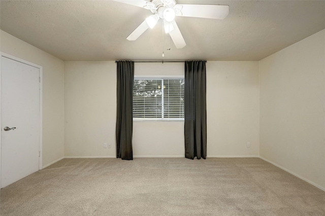 unfurnished room featuring ceiling fan and light carpet