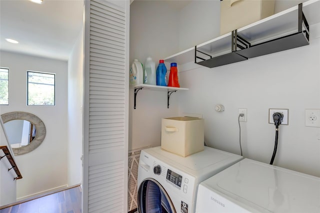 laundry area featuring independent washer and dryer and hardwood / wood-style flooring