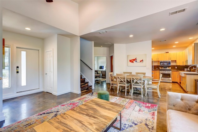 living room featuring sink and concrete flooring