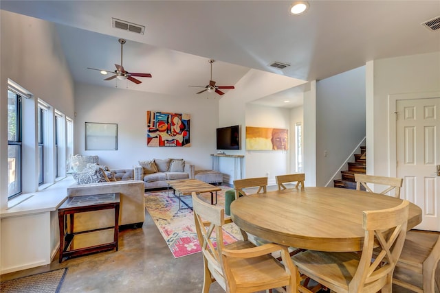 dining room with vaulted ceiling and concrete floors