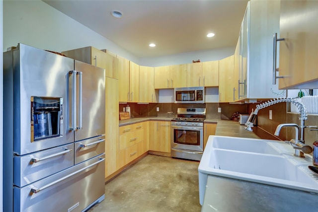 kitchen featuring sink, light brown cabinets, backsplash, and stainless steel appliances